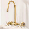 Unlacquered brass wall mount bridge faucet with gooseneck spout and ball center
