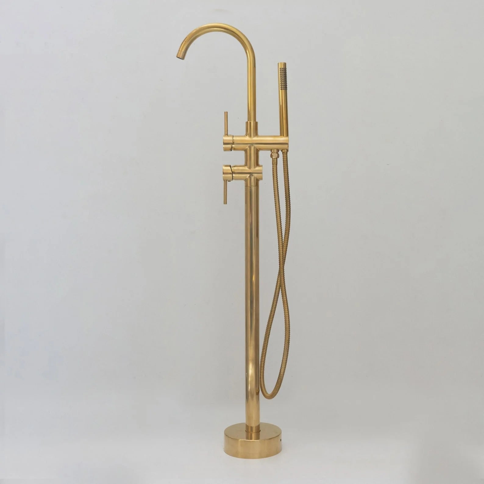 Unlacquered brass freestanding tub filler with hand shower