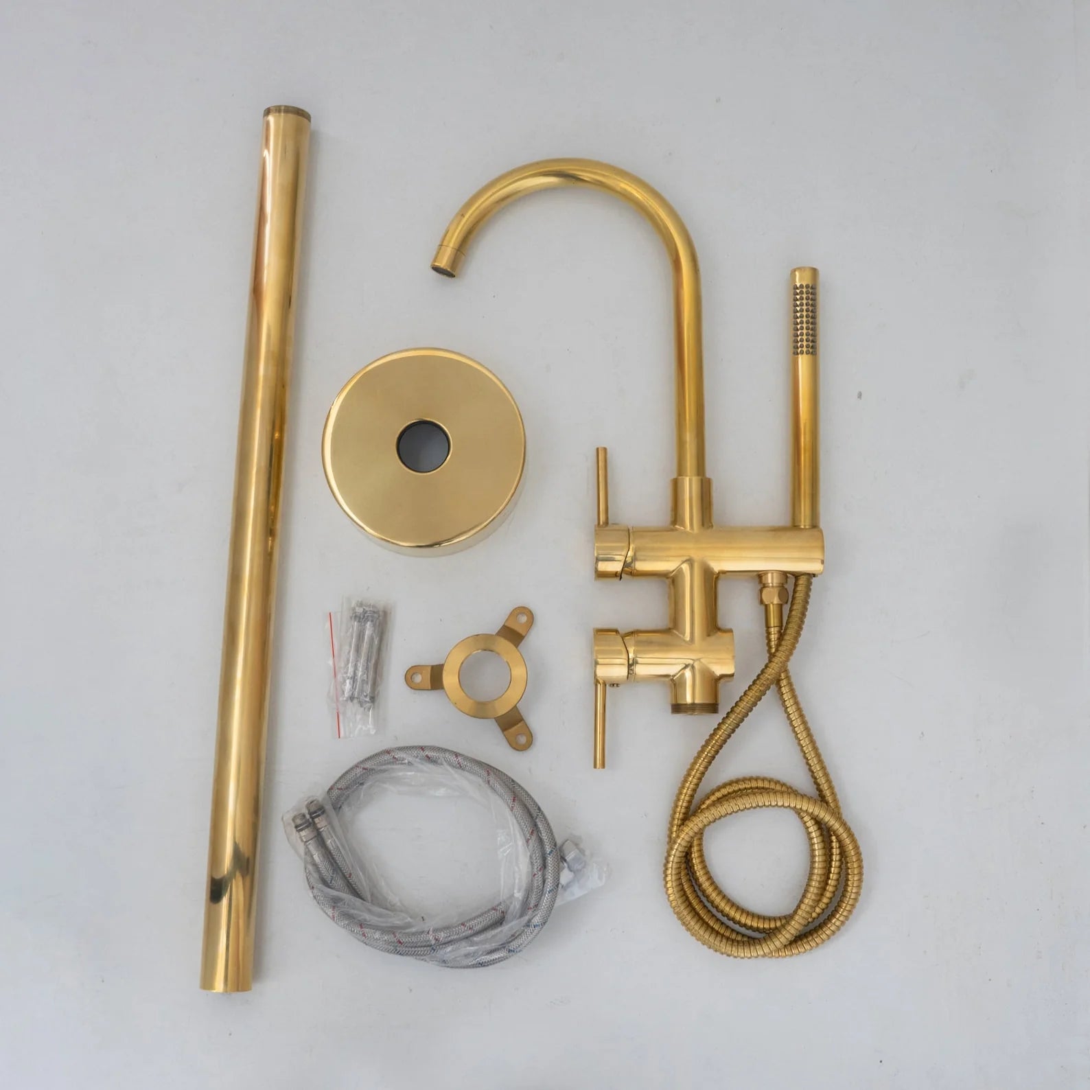 Unlacquered brass freestanding tub filler with hand shower