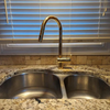 Close-up of unlacquered brass handle and spray head, antique finish