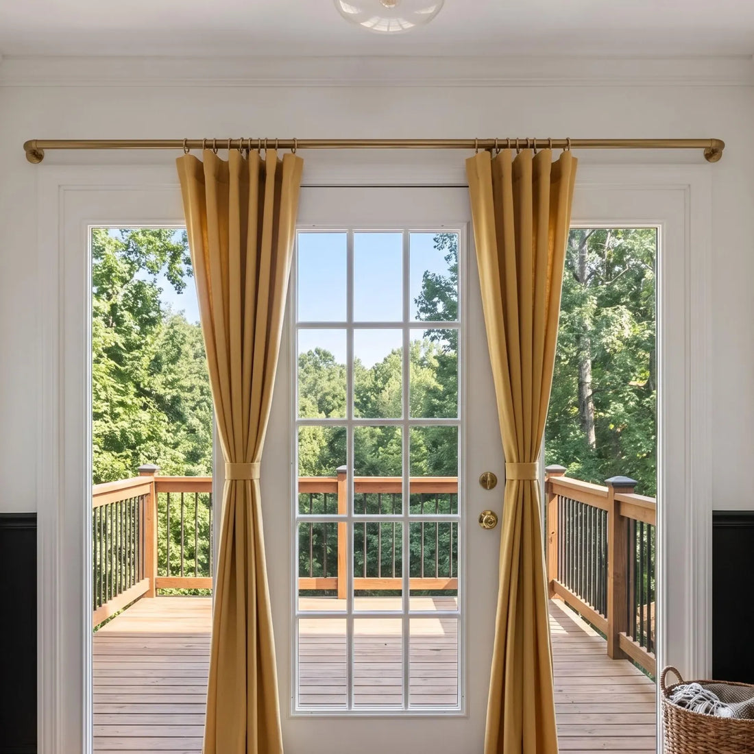 Unlacquered brass French return curtain rod installed above kitchen window