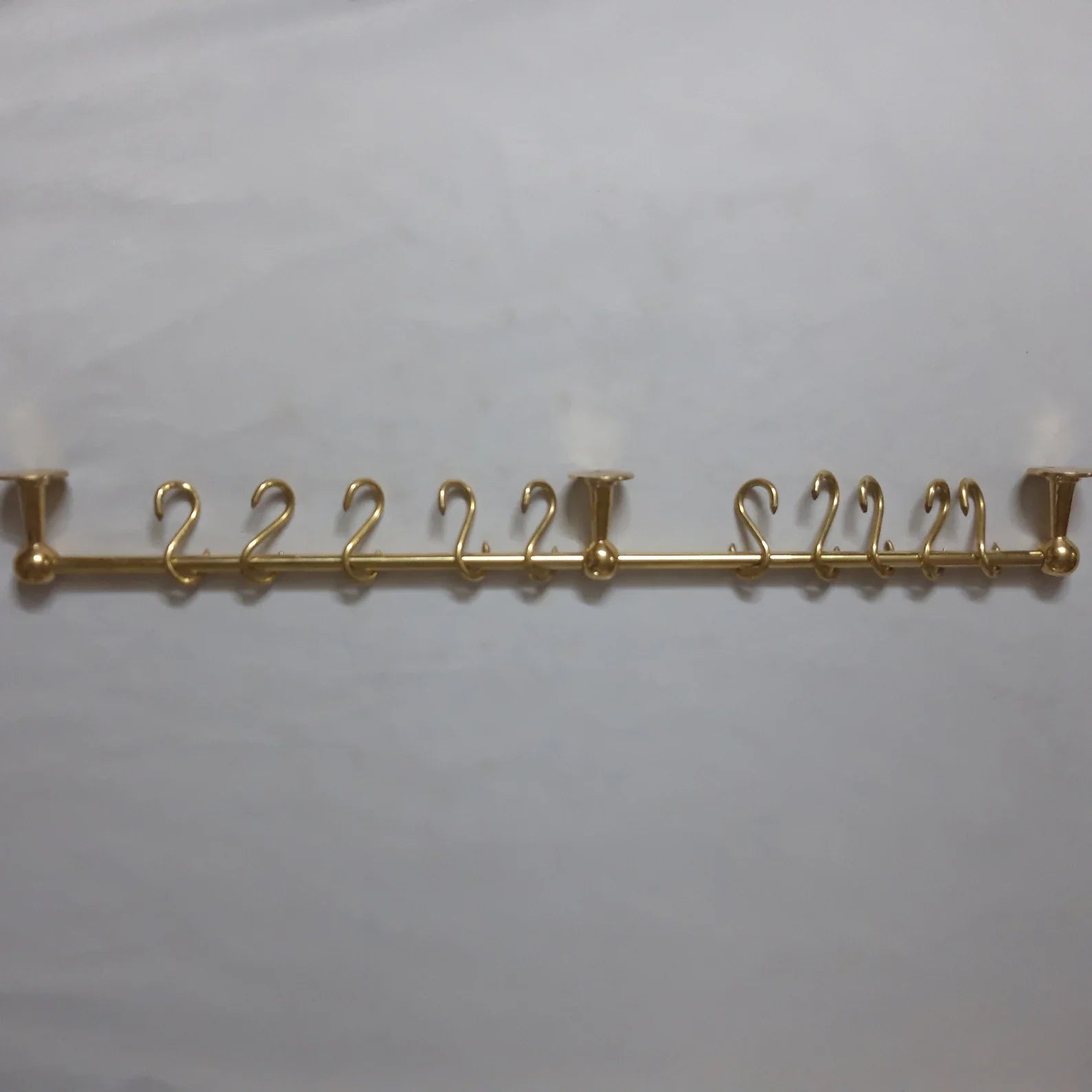 Unlacquered brass pot rack with solid brass S-hooks