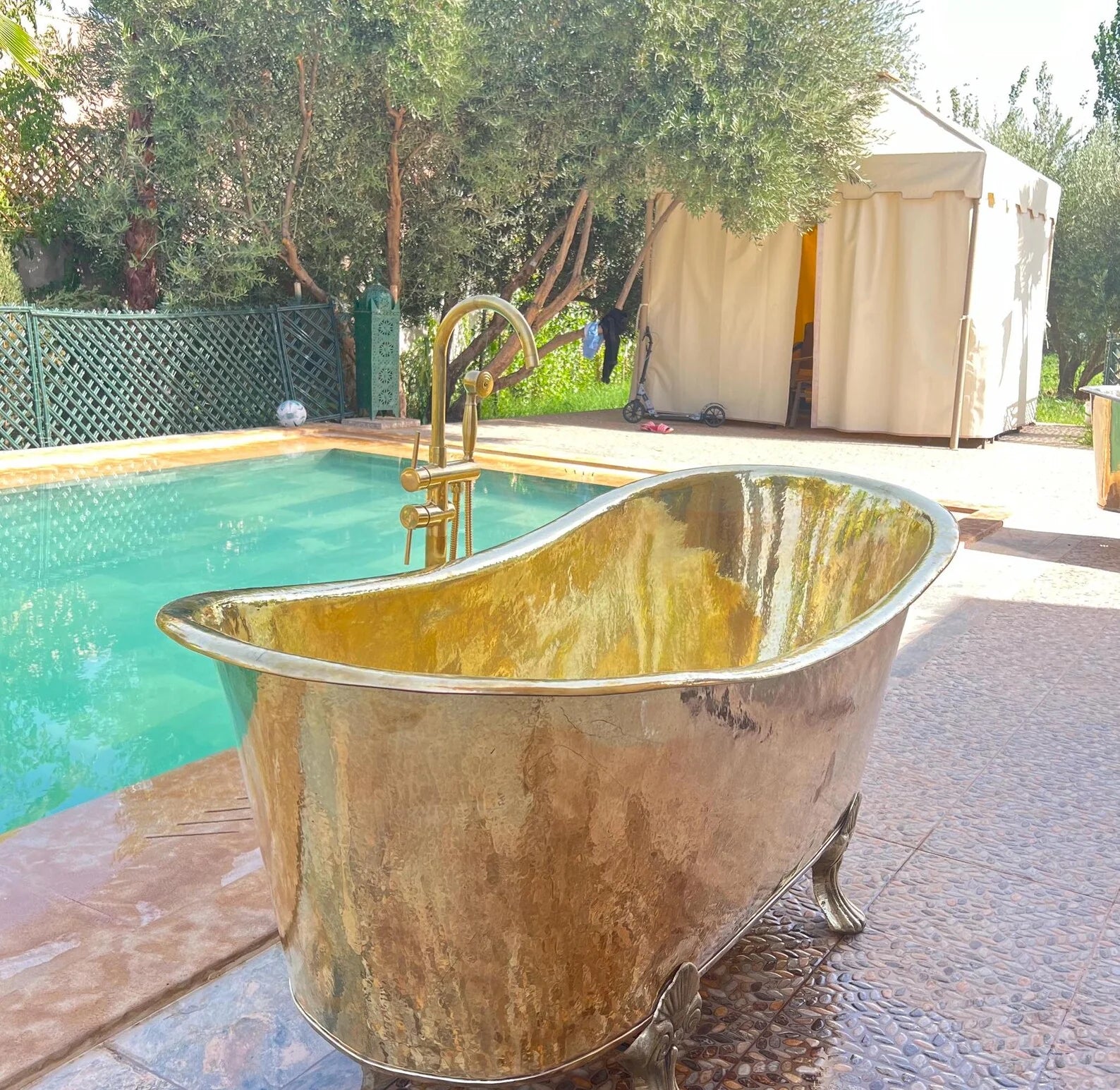 Unlacquered brass freestanding tub filler with vintage hand shower