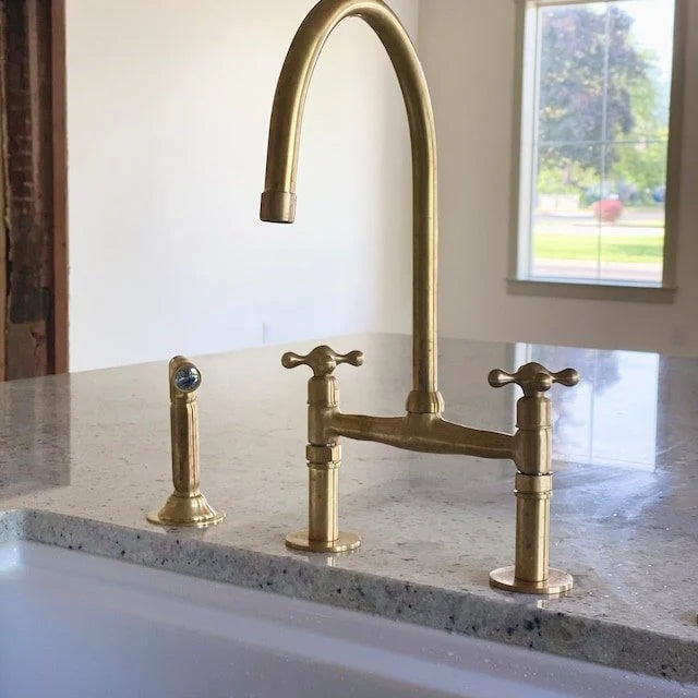 Unlacquered brass kitchen faucet with linear legs