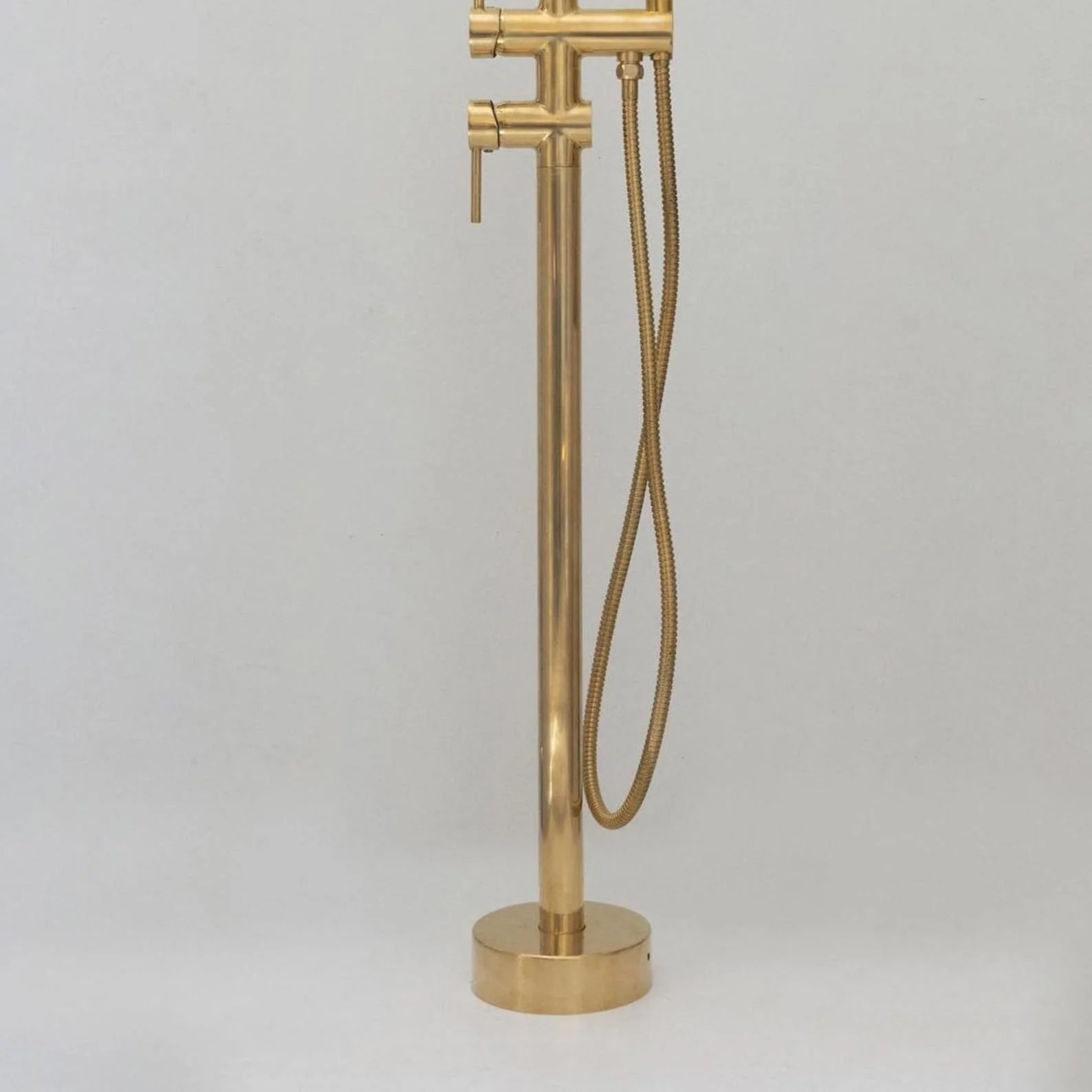 Unlacquered brass freestanding tub filler with vintage hand shower