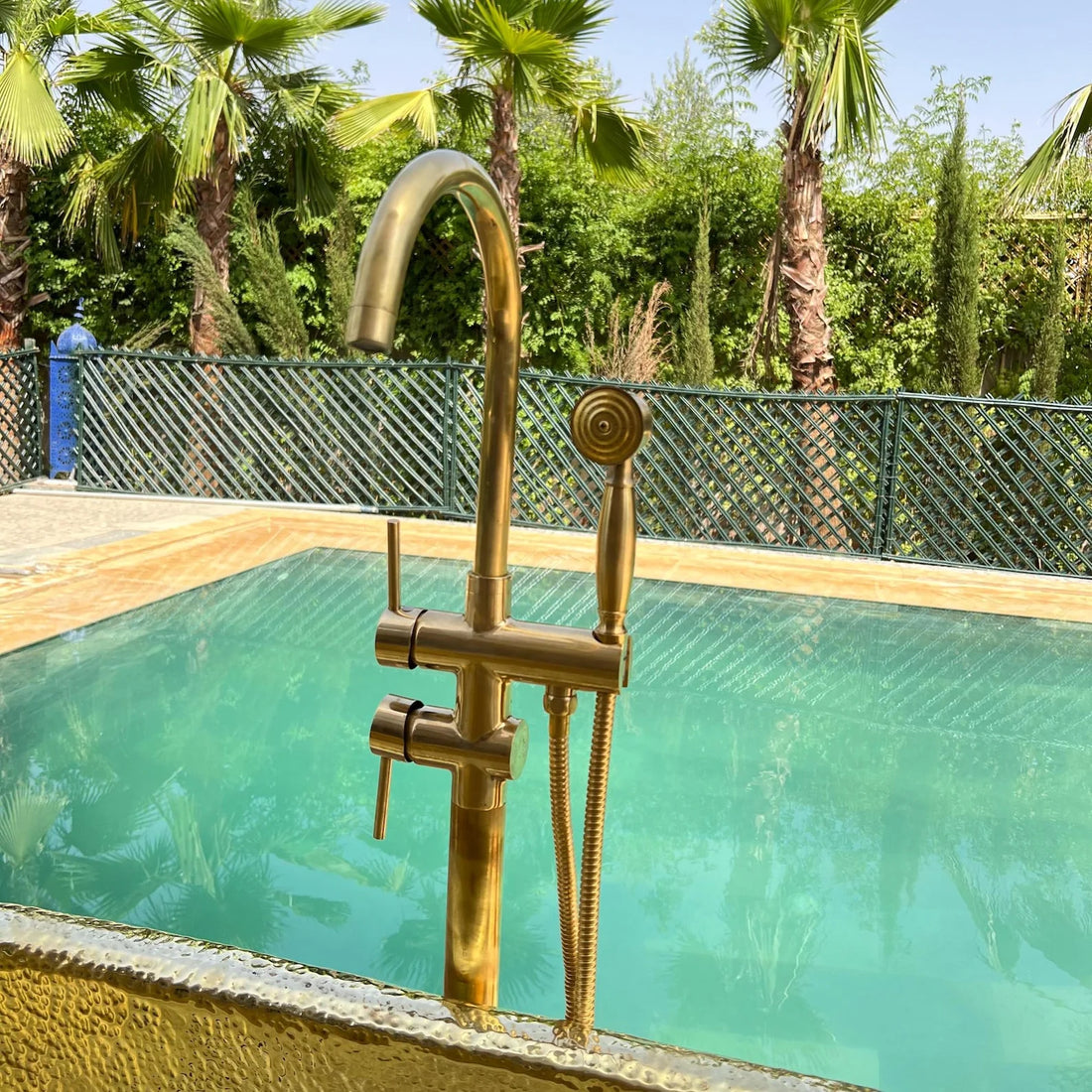 Unlacquered brass freestanding tub filler with vintage hand shower