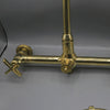 Unlacquered brass wall mount kitchen faucet with sprayer, 8 inch spread
