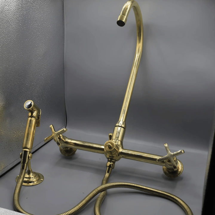 Unlacquered brass wall mount kitchen faucet with sprayer, 8 inch spread
