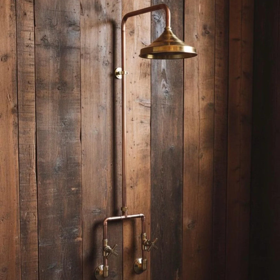 Solid copper outdoor shower system with an eight inch rain head and exposed riser